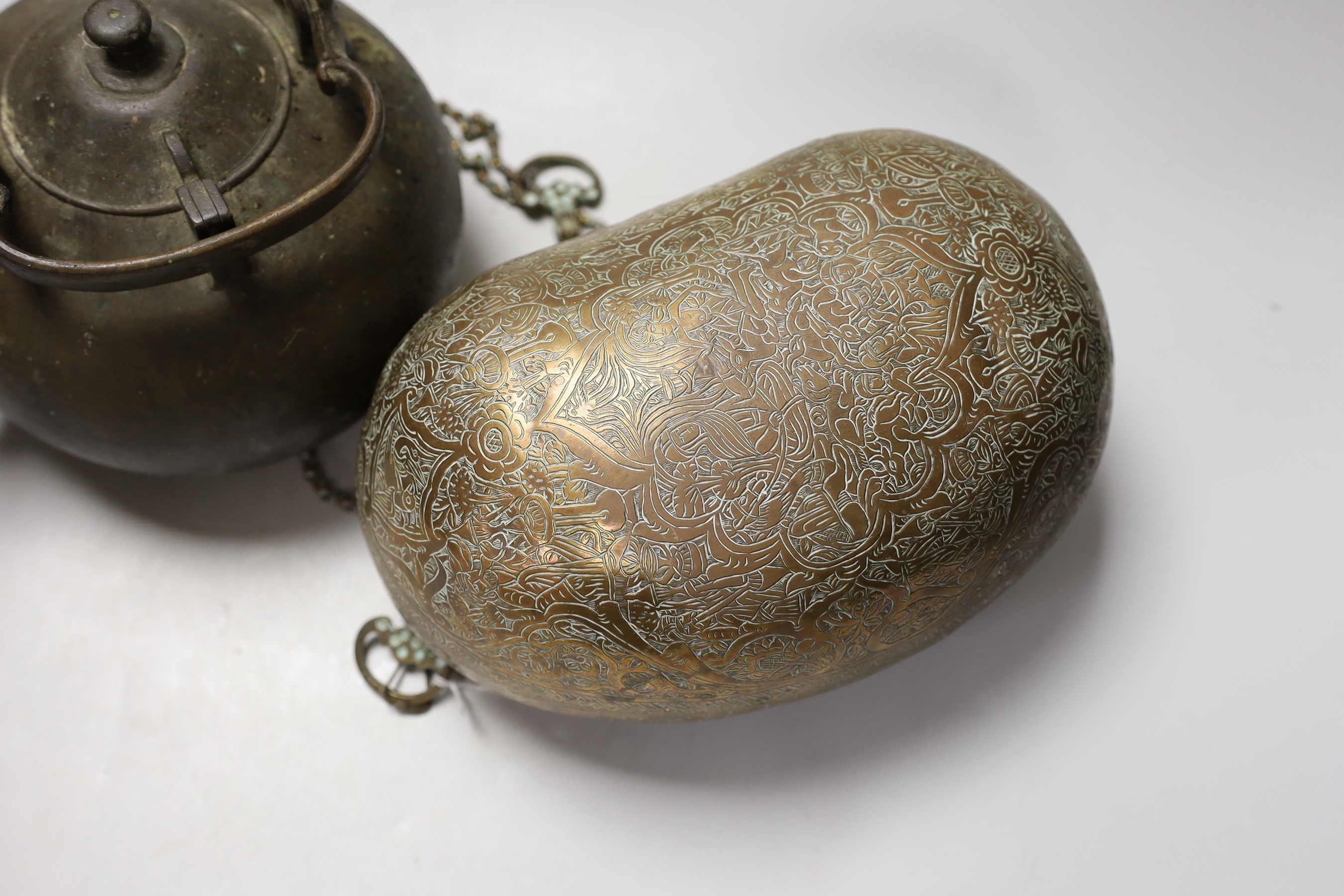 A 19th century Persian engraved brass kashkul, Qajar dynasty, 16cm wide and a bronze kettle, 17cm tall